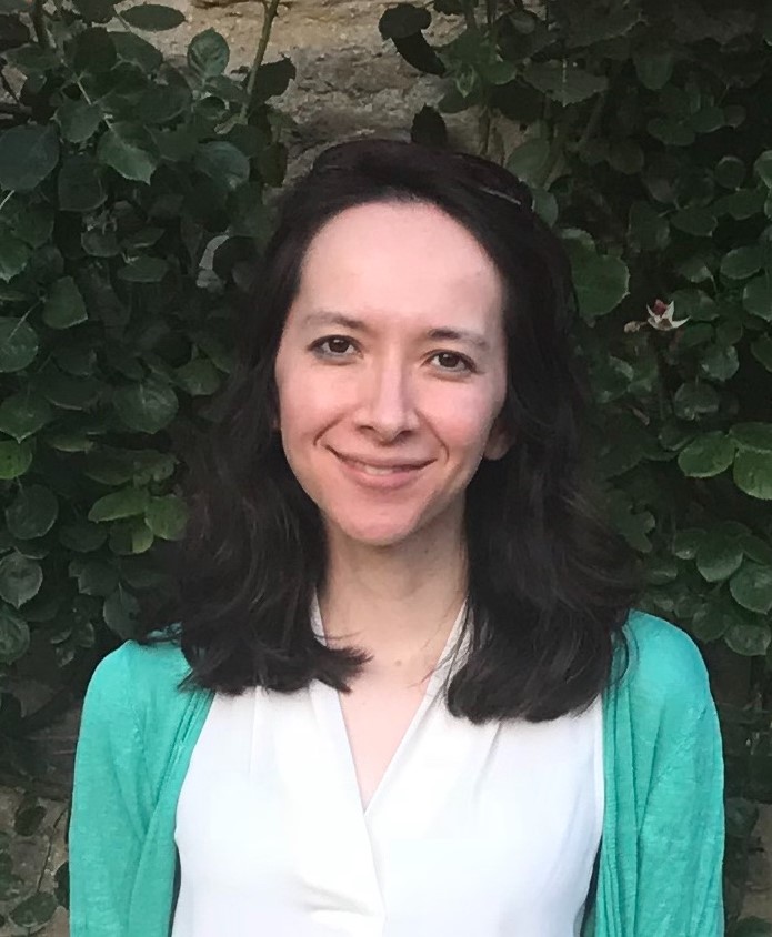 Isabel Huang-Doran headshot wearing green cardigan with long dark hair