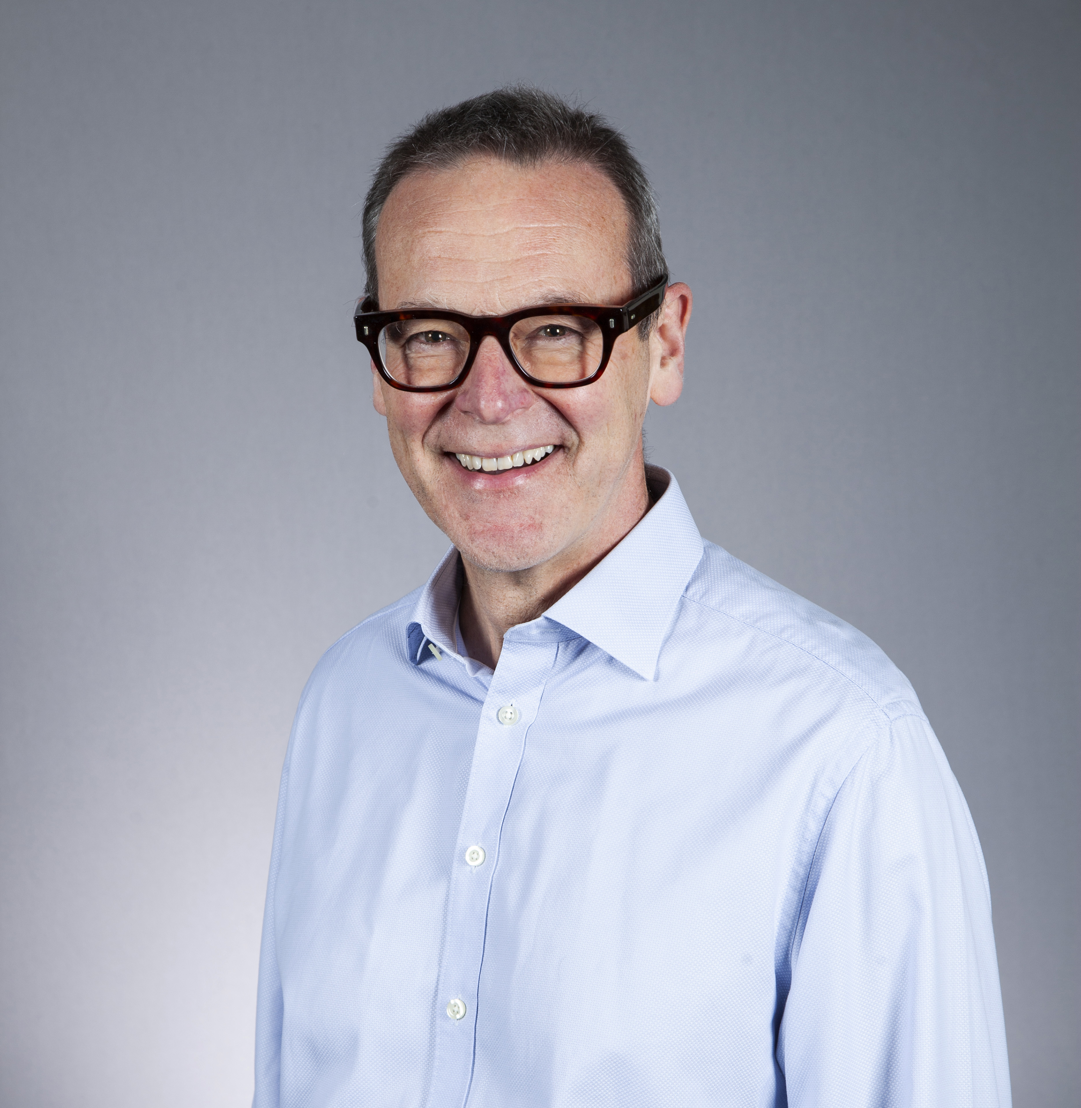 Smiling person in pale blue shirt