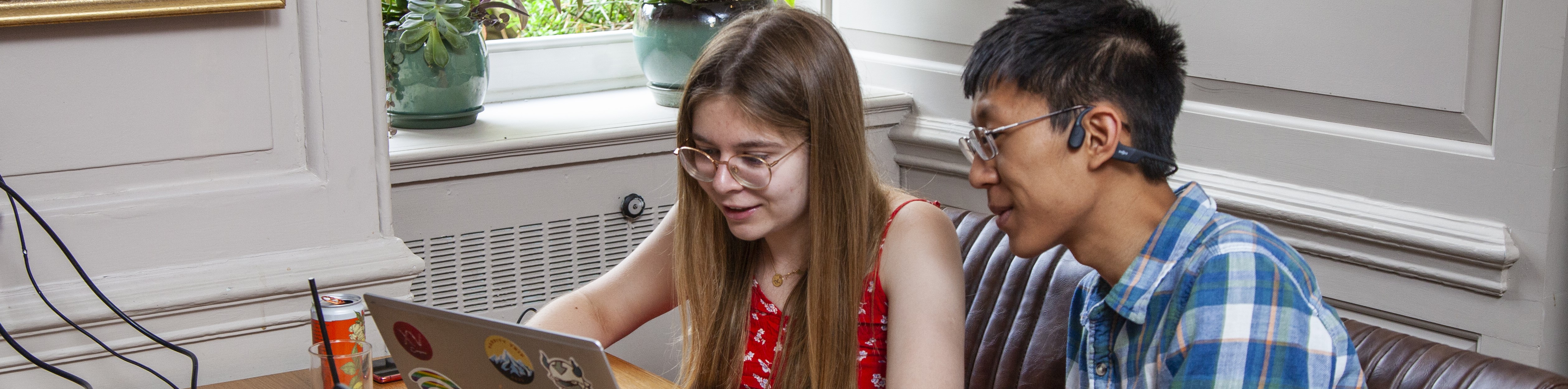 Students looking at laptop