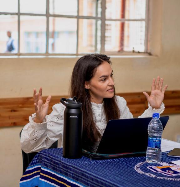 Person sitting at a table with a laptop