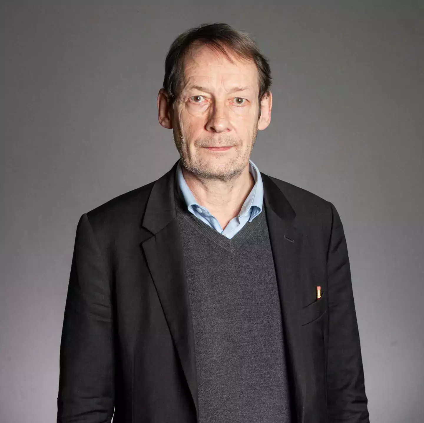 Nick Gay headshot in dark jacket and jumper