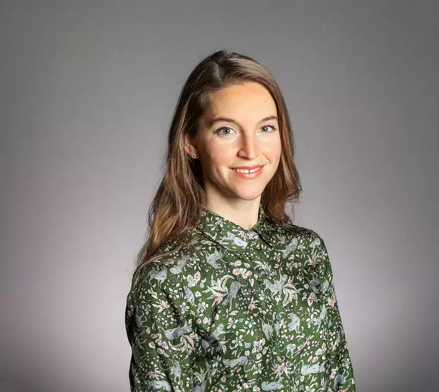 Camilla Nord headshot wearing green paisley shirt