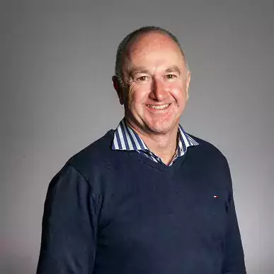 Michael Parsons headshot wearing jumper and shirt