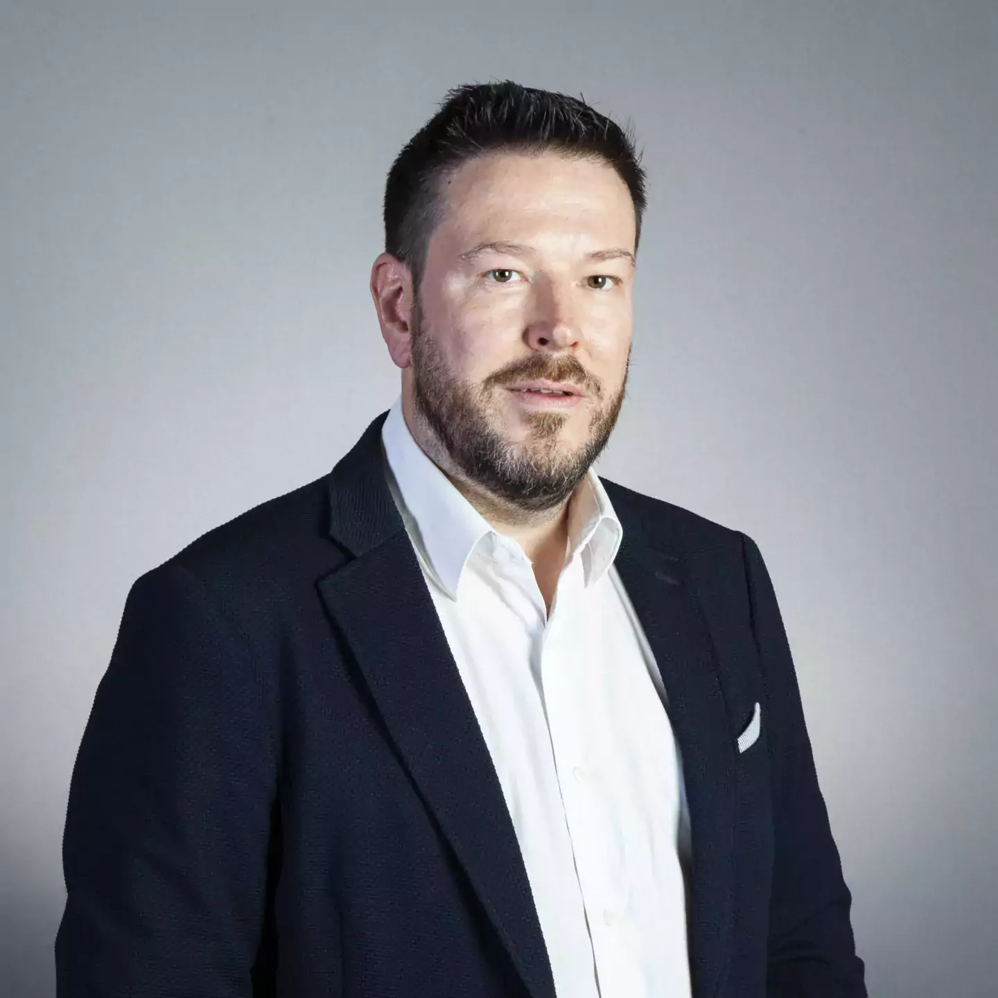 Duncan Bell headshot wearing black jacket