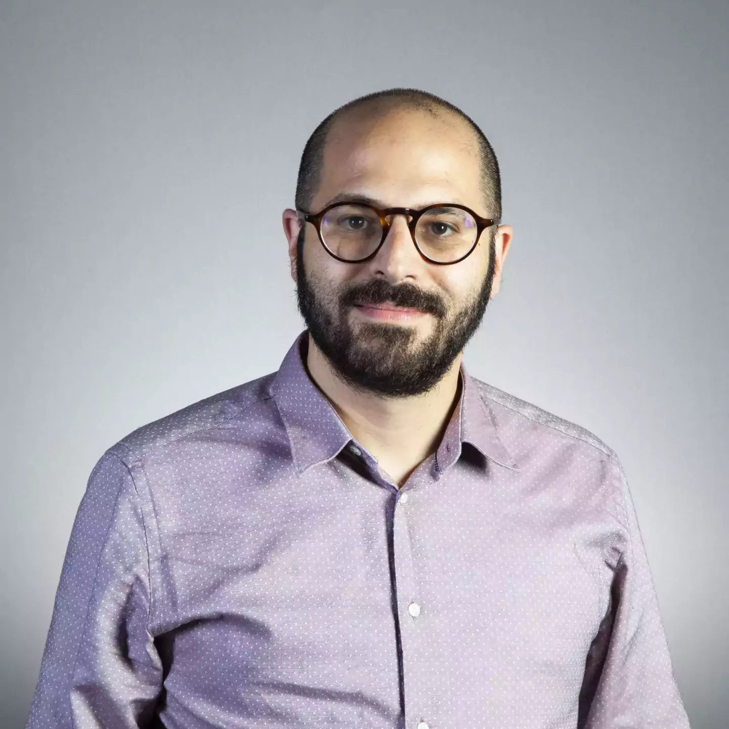 Kareem Estefan headshot with beard and wearing glasses